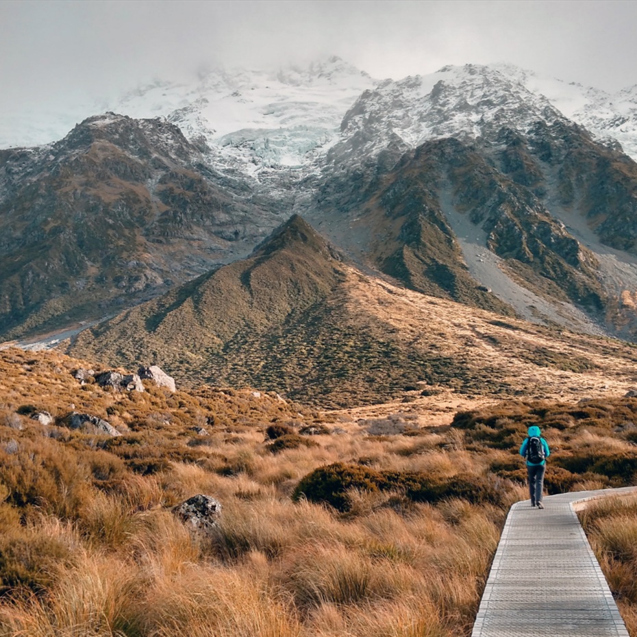 Hiker on boardwalk through mountains